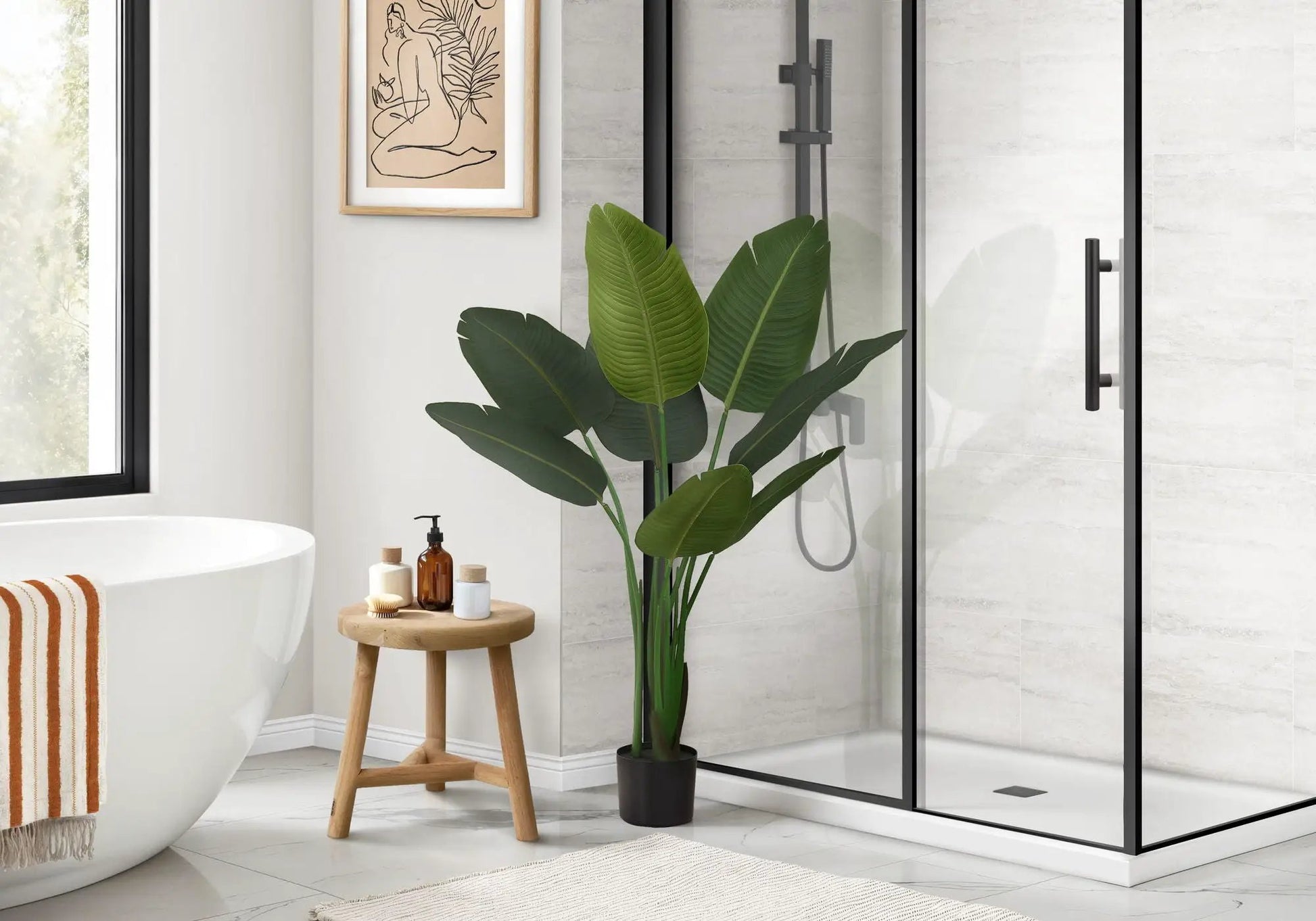 Bird of Paradise faux plant, 44 in tall in black pot with green leaves beside shower in bathroom on Tampa Home & Garden Store