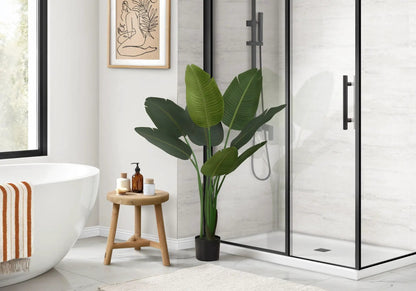Bird of Paradise faux plant, 44 in tall in black pot with green leaves beside shower in bathroom on Tampa Home & Garden Store