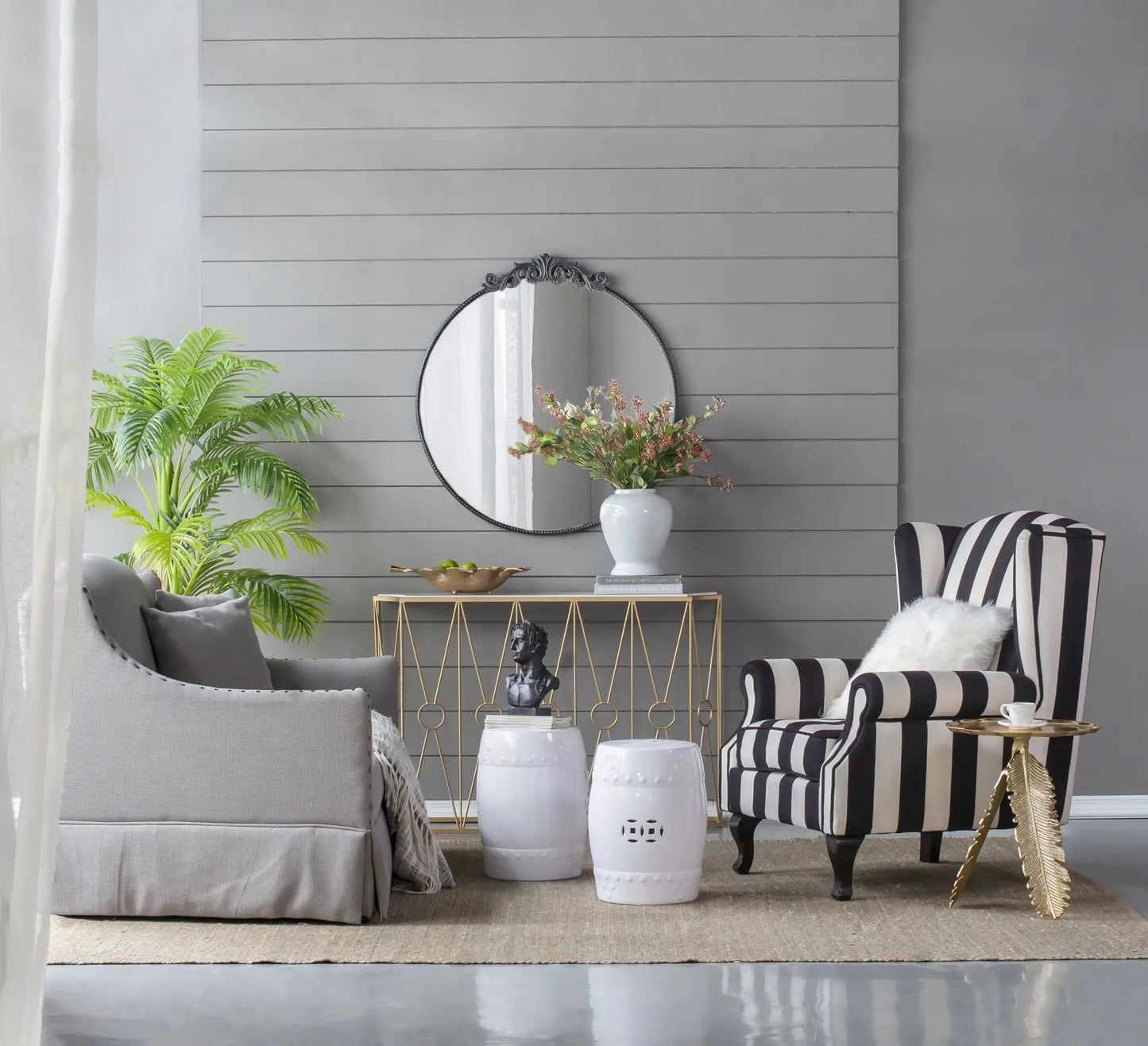 Classic design wall mirror with Baroque-inspired black frame, round shape leaning on gray wall on Tampa Home & Garden Store