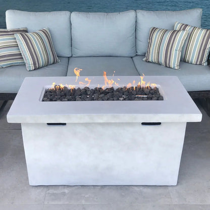 Reinforced propane outdoor fire pit table in white concrete with lava rock and flames on Tampa Home & Garden Store
