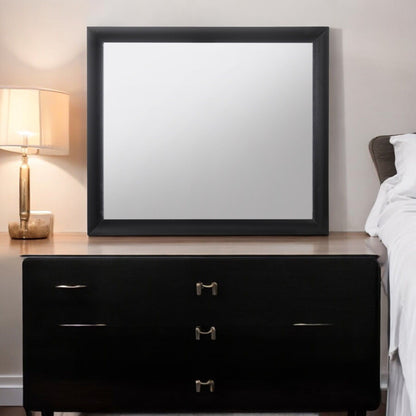 Ireland Contemporary Design Mirror with black frame on a black dresser in a bedroom on Tampa Home & Garden Store