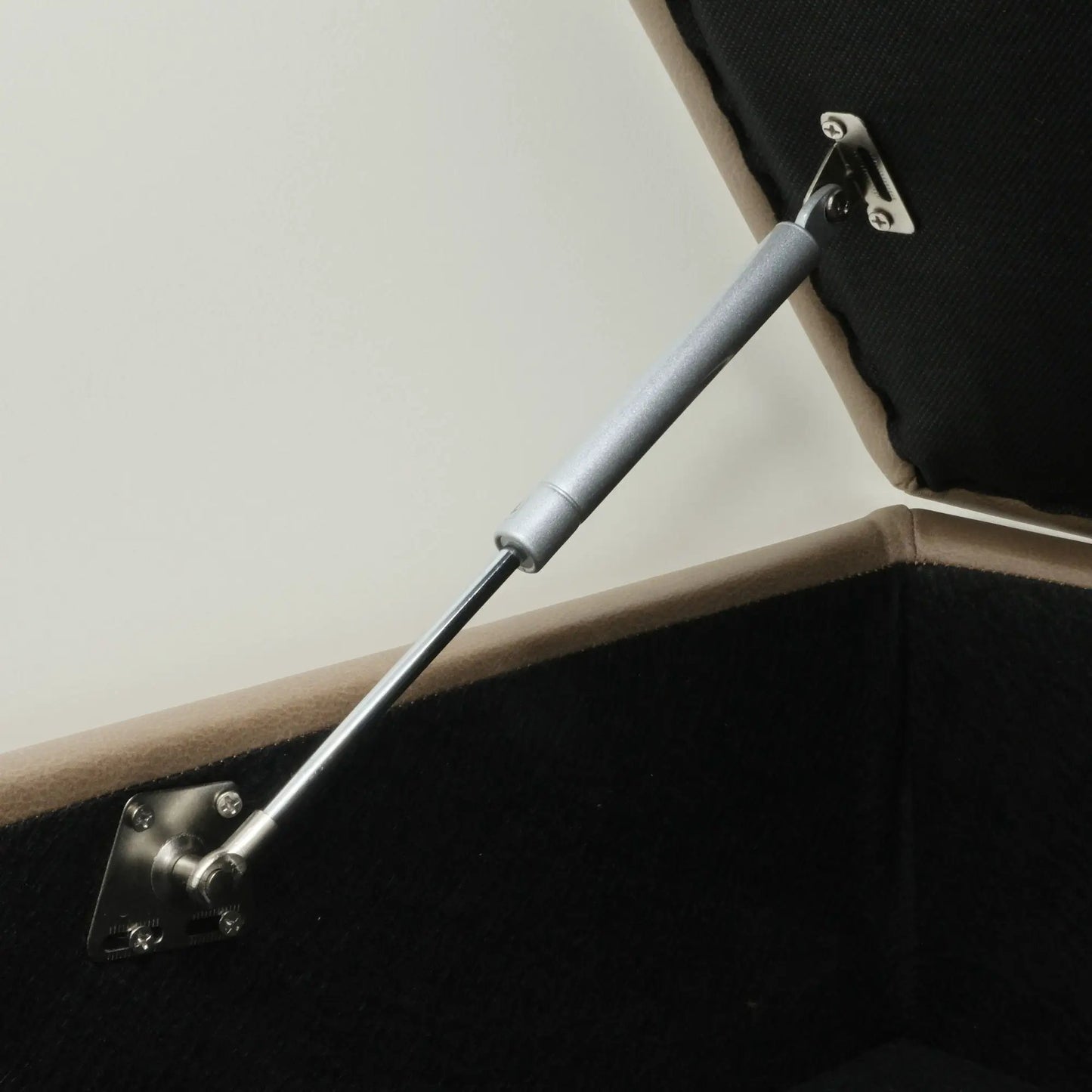 Drason storage ottoman close-up with brown fabric and silver metal leg hardware on Tampa Home & Garden Store