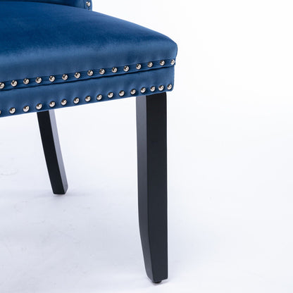 Blue velvet tufted dining chair with nailhead trim and black wooden legs on Tampa Home & Garden Store