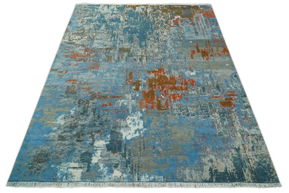 Beige and blue hand-knotted wool and silk area rug with abstract pattern and fringed ends 8x10 on Tampa Home & Garden Store