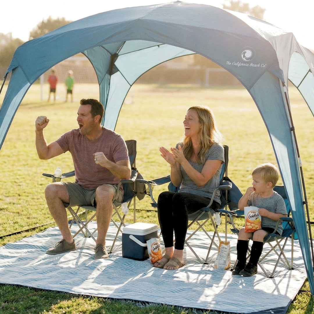 Pop 'N Go Canopy blue shelter by The California Beach Co. LLC; family of three under shade on Tampa Home & Garden Store