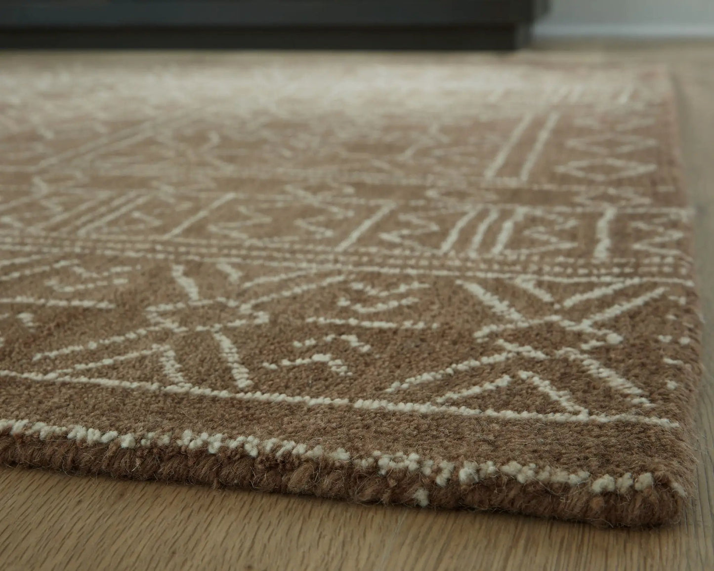 Merrittman rug, brown area rug with cream geometric lattice pattern and plush rolled edge on Tampa Home & Garden Store