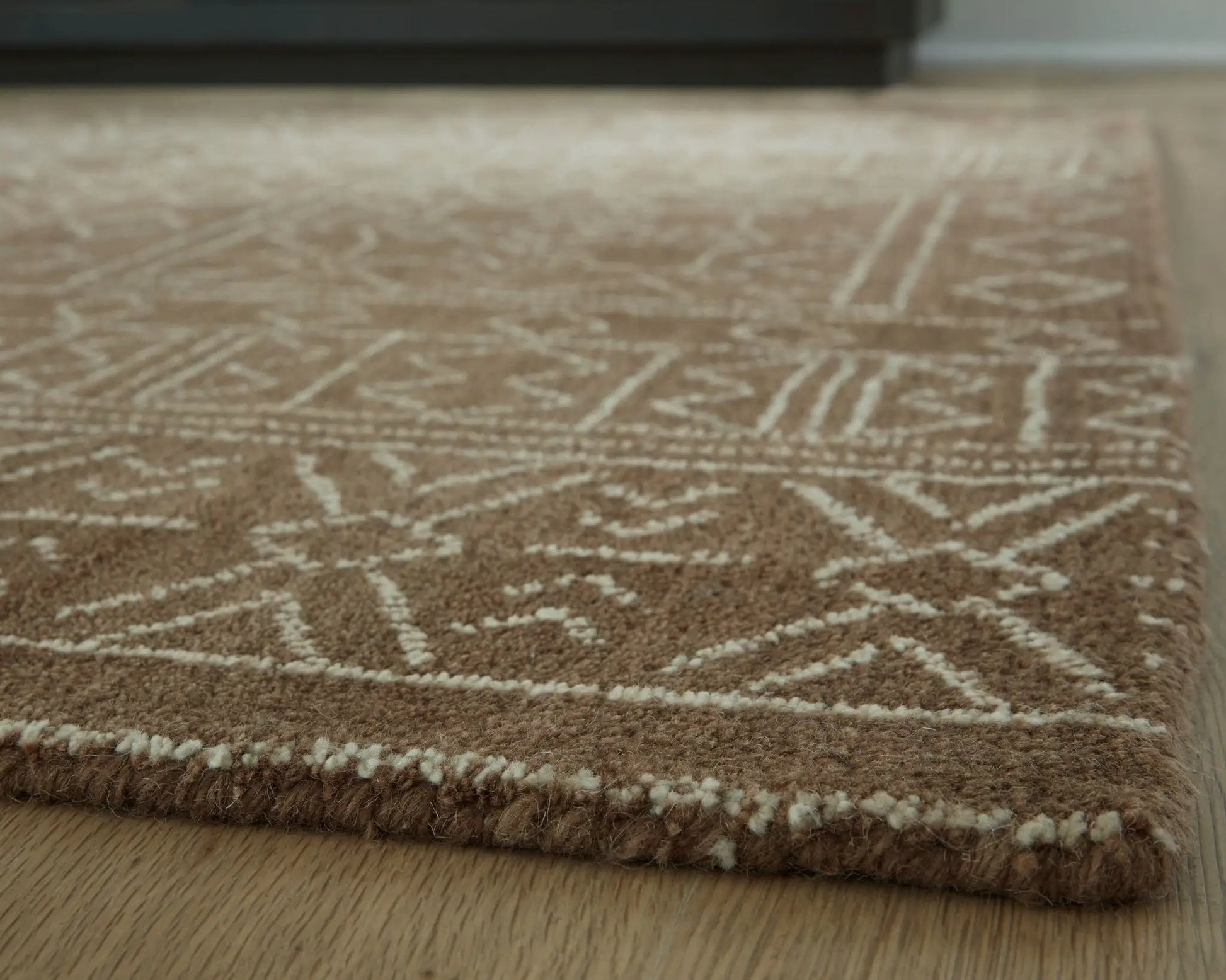 Merrittman rug, brown area rug with cream geometric lattice pattern and plush rolled edge on Tampa Home & Garden Store