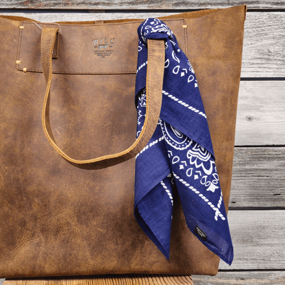 Will's Bandana blue bandana with white print tied to tan leather tote by Will Leather Goods on Tampa Home & Garden Store