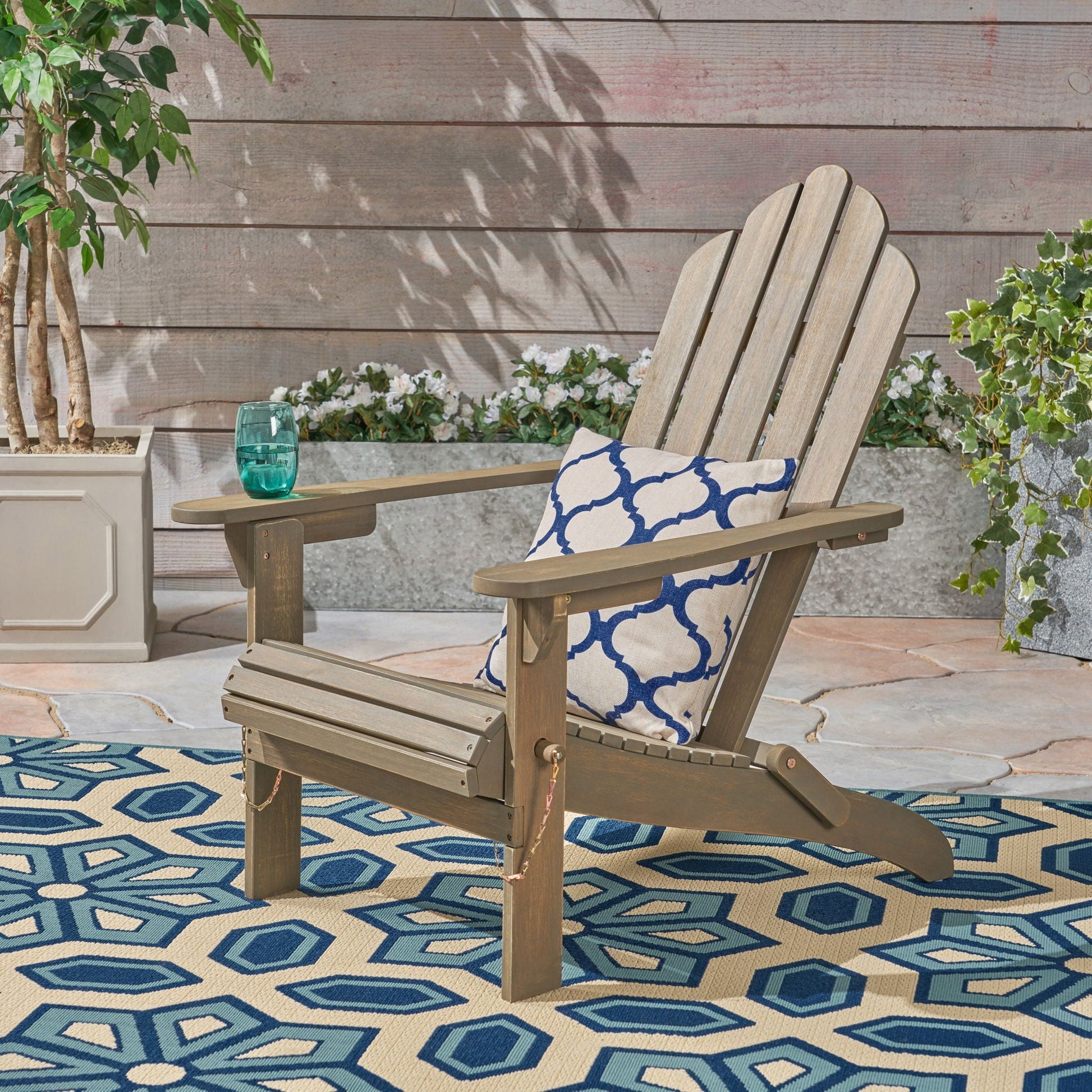 Outdoor foldable Adirondack chair with gray wood and blue-patterned cushion on Tampa Home & Garden Store