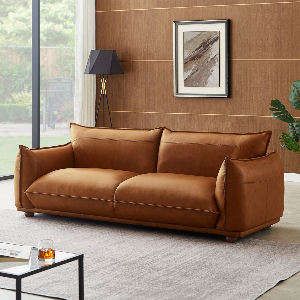 Mid-Century modern leather sofa in tan brown with clean lines on Tampa Home & Garden Store