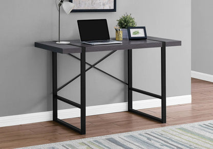 Industrial design computer desk with dark wood top and black metal frame, laptop setup on Tampa Home & Garden Store