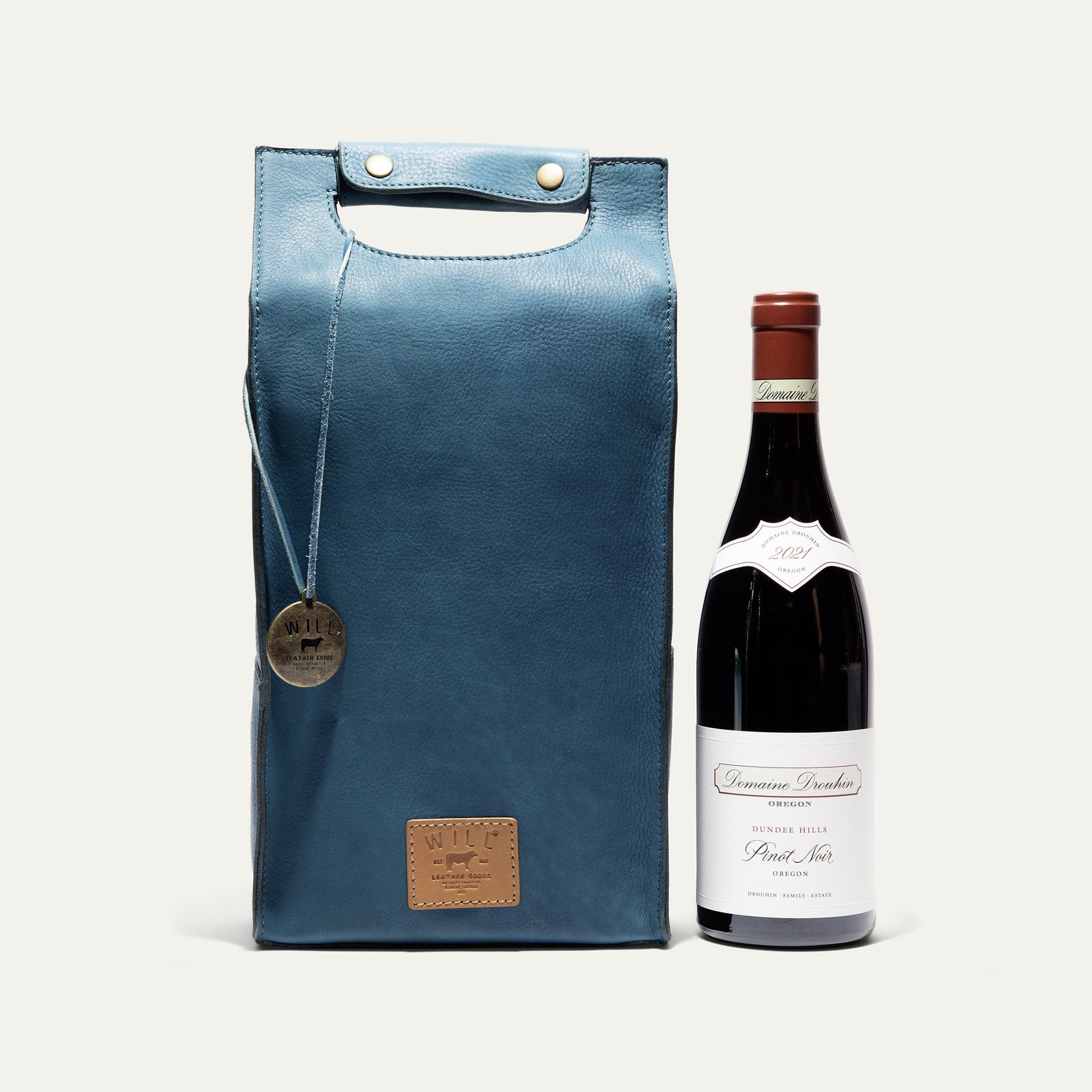 Double Leather Wine Case blue leather wine carrier with brass snaps beside wine bottle on Tampa Home & Garden Store