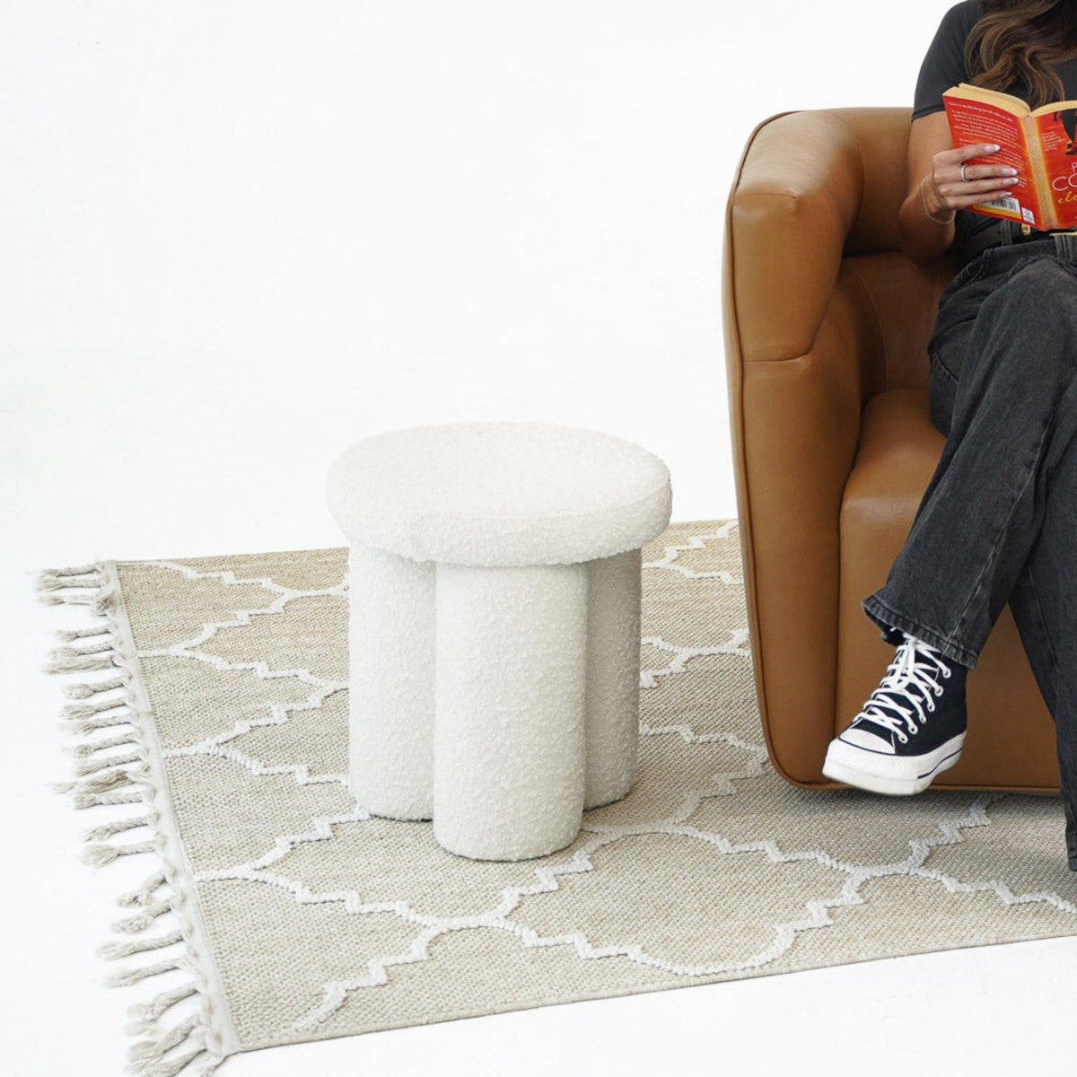 Ivory Sherpa upholstered accent stool Wesley, plush round seat beside tan leather armchair on Tampa Home & Garden Store