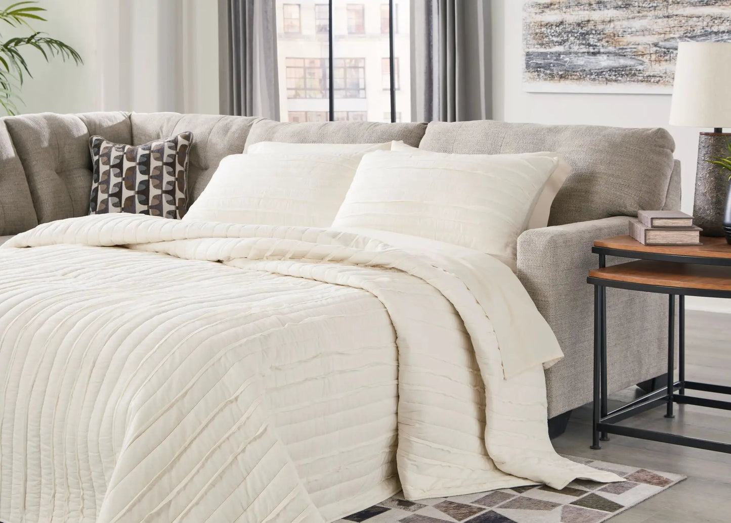 Mahoney sectional sofa beige fabric with white quilted throw and 1 pillow Unique Piece Furniture on Tampa Home & Garden Store