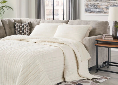 Mahoney sectional sofa beige fabric with white quilted throw and 1 pillow Unique Piece Furniture on Tampa Home & Garden Store