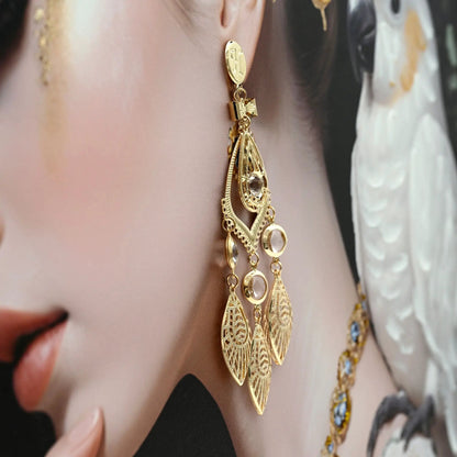 Gold statement necklace with crystal pendants and intricate filigree on ivory fabric on Tampa Home & Garden Store