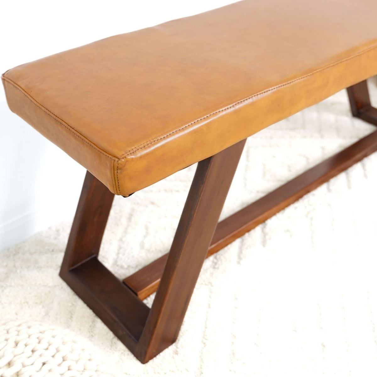 Upholstered bench in light brown leather by HouseOfZazla with hand stitching and dark wood legs on Tampa Home & Garden Store