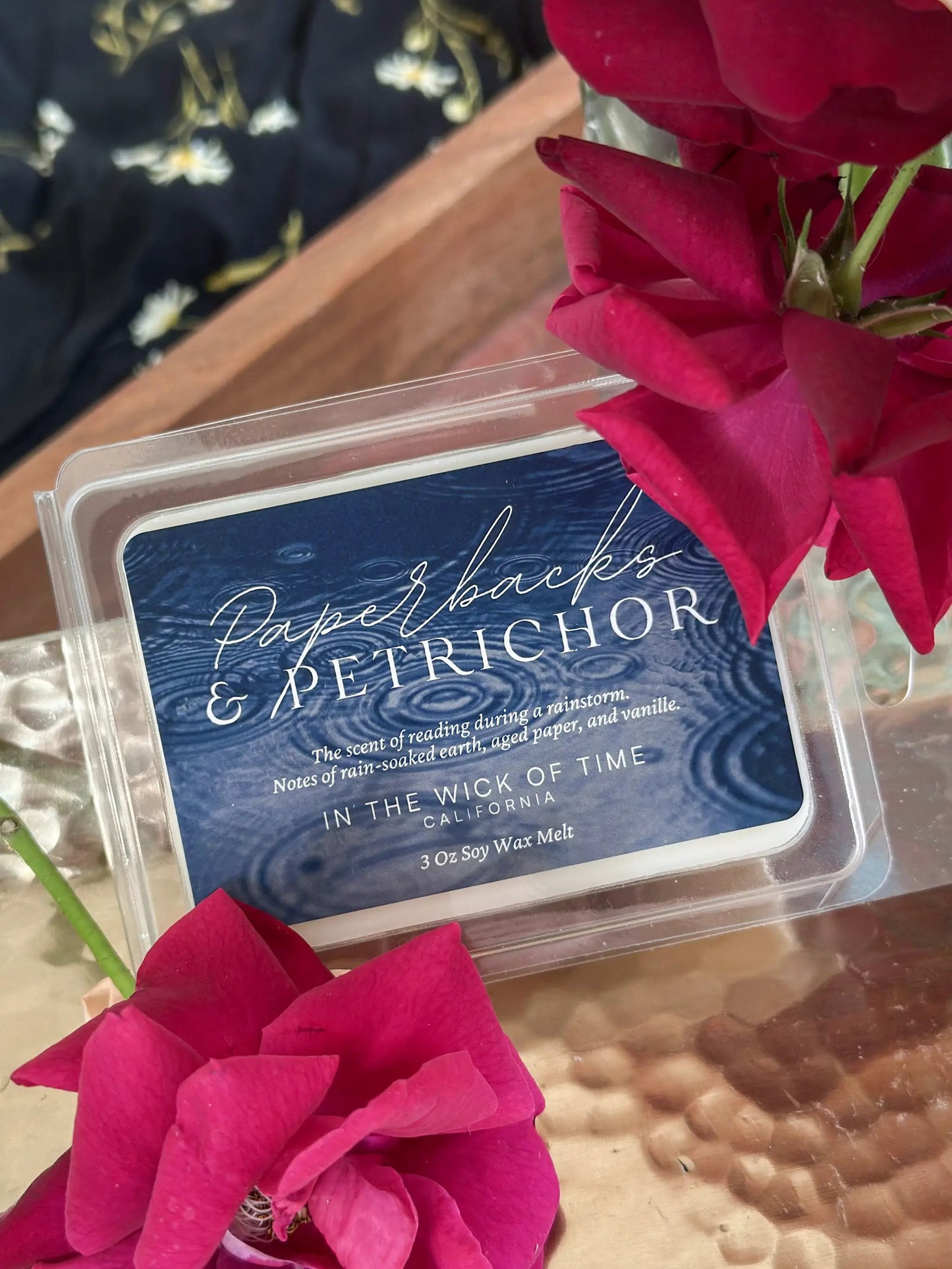Wax melt Paperbacks and Petrichor by In the Wick of Time in a blue clamshell with pink rose accent on Tampa Home & Garden Store