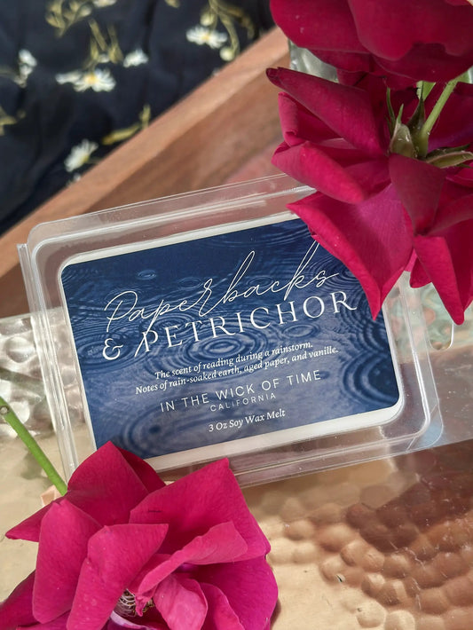Wax melt Paperbacks and Petrichor by In the Wick of Time in a blue clamshell with pink rose accent on Tampa Home & Garden Store