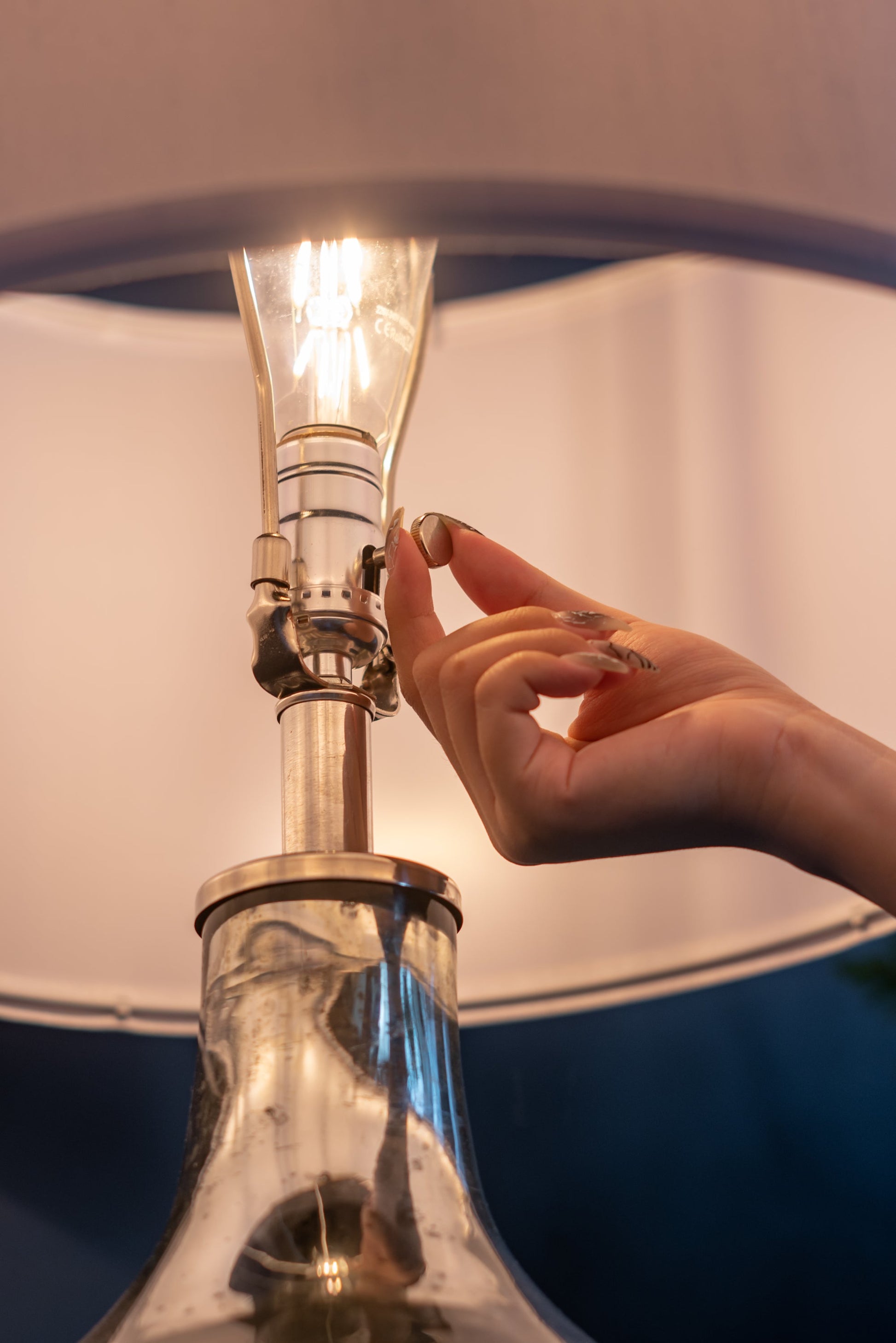 Silver round table lamp with glass body, Edison bulb, hand adjusting switch on Tampa Home & Garden Store