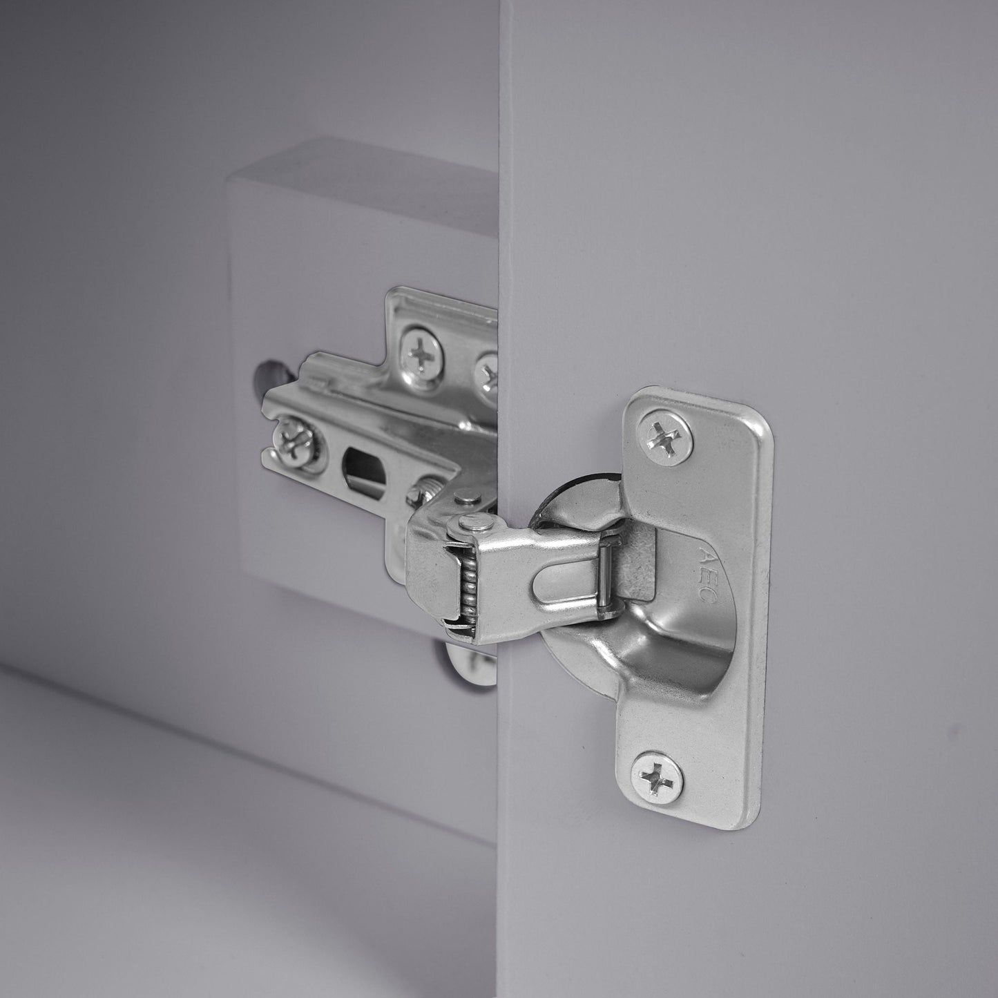 Silver cabinet hinge hardware with visible screws mounted on a gray cabinet door on Tampa Home & Garden Store