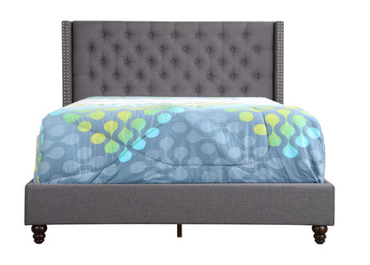Nailhead Bed gray tufted bed with studded sides and dark legs vibrant quilt on Tampa Home & Garden Store
