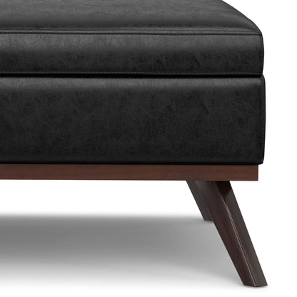 Square lift-top coffee table and storage ottoman in black faux leather with dark wood legs on Tampa Home & Garden Store