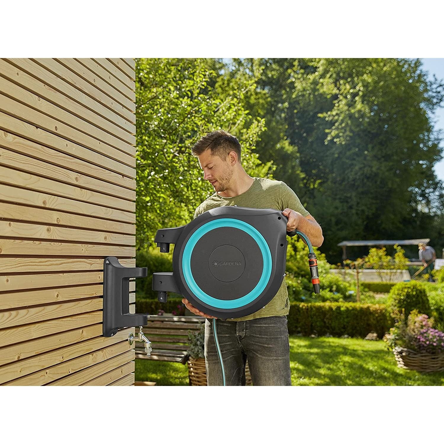 Wall-Mounted Hose Box RollUp XL 35m by Gardena, gray housing with teal ring on wall bracket on Tampa Home & Garden Store