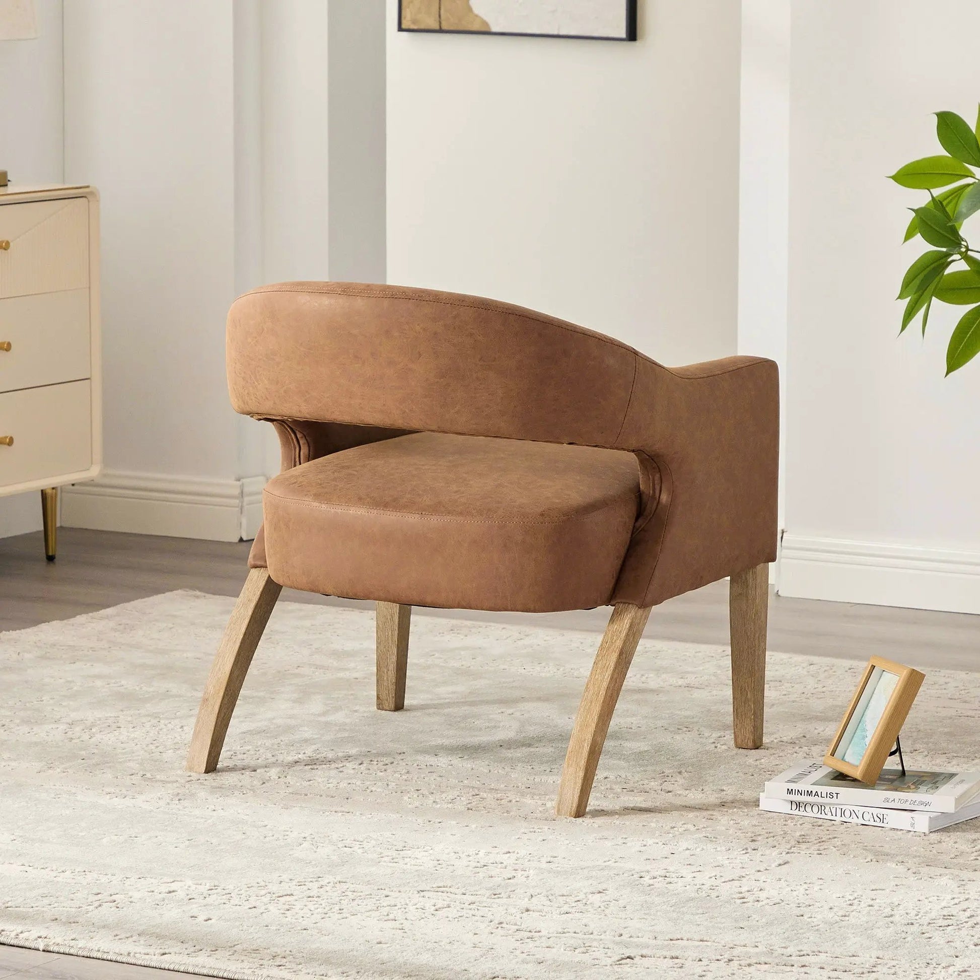 Upholstered open-back armchair with brown leather upholstery and weathered rubberwood legs on Tampa Home & Garden Store