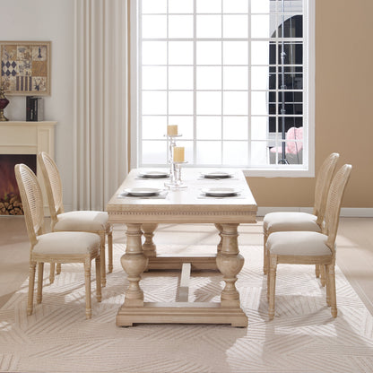 French Country dining chairs with beige upholstered seats and rattan backs around a wooden table on Tampa Home & Garden Store