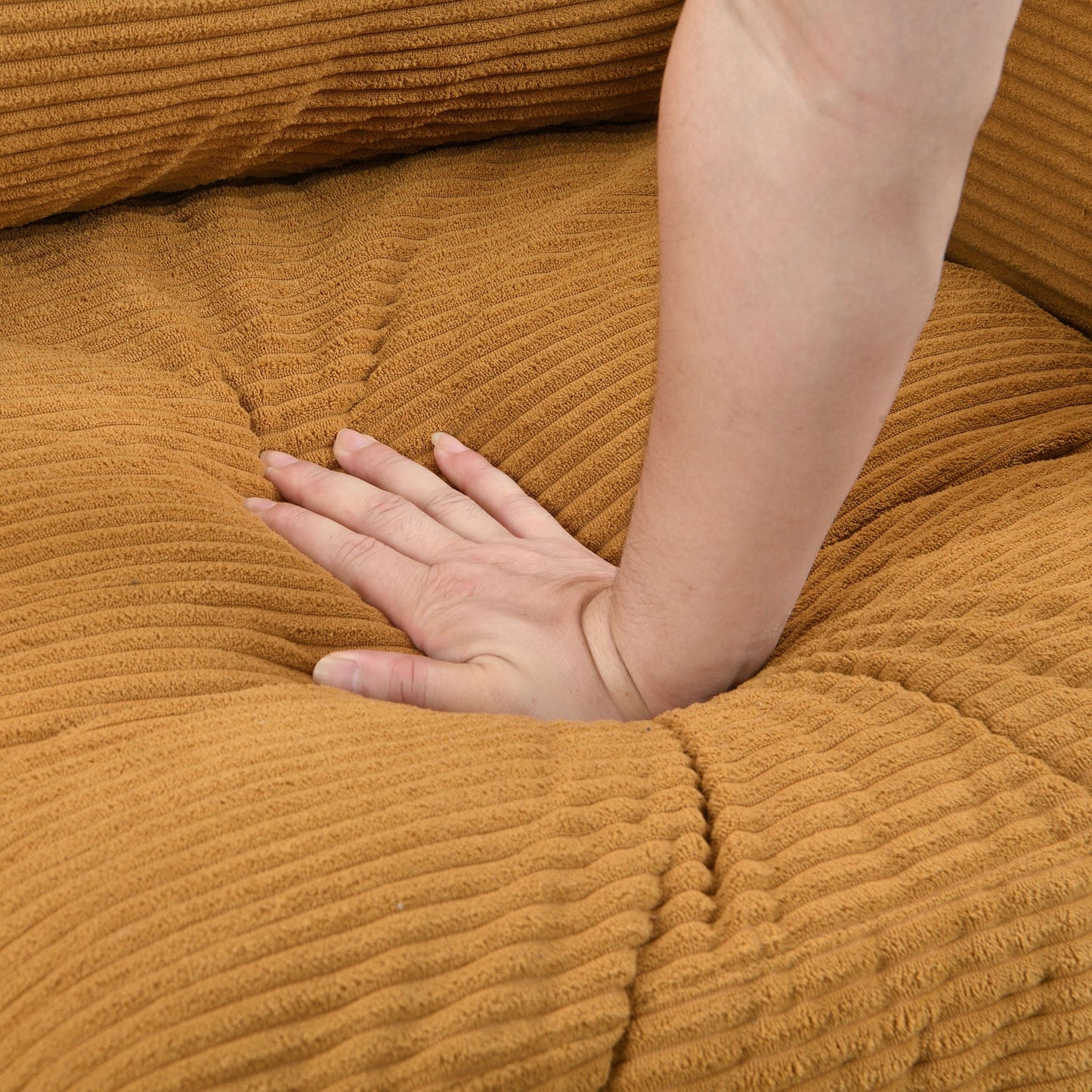 Modern Upholstered Loveseat Sofa close-up of warm brown textured fabric being pressed by hand on Tampa Home & Garden Store