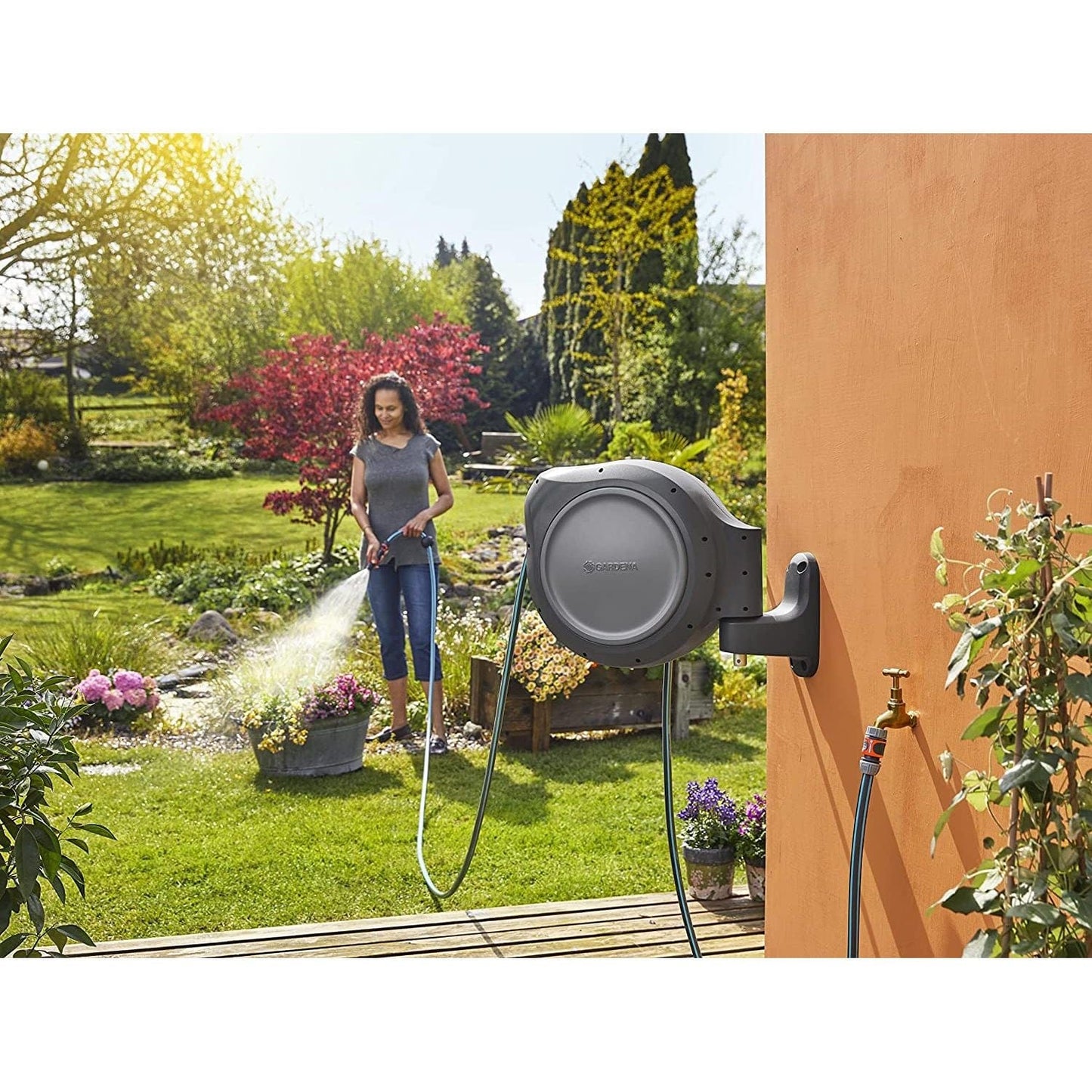 Gardena Retractable Hose Reel RollUp 75 ft wall-mount gray unit with hose in sunny garden on Tampa Home & Garden Store