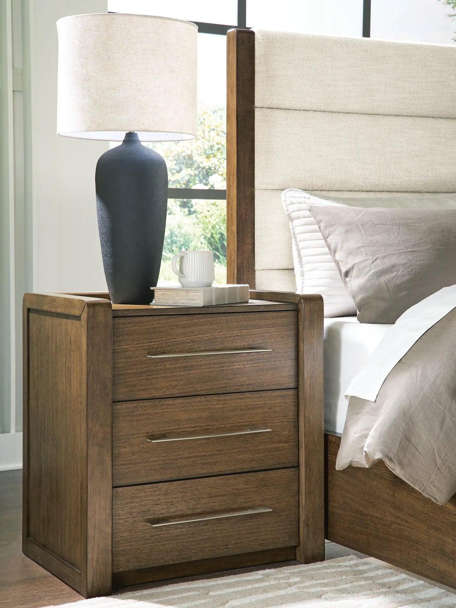 Marxmore three-drawer brown wood nightstand with metal bar handles and wood grain finish on Tampa Home & Garden Store
