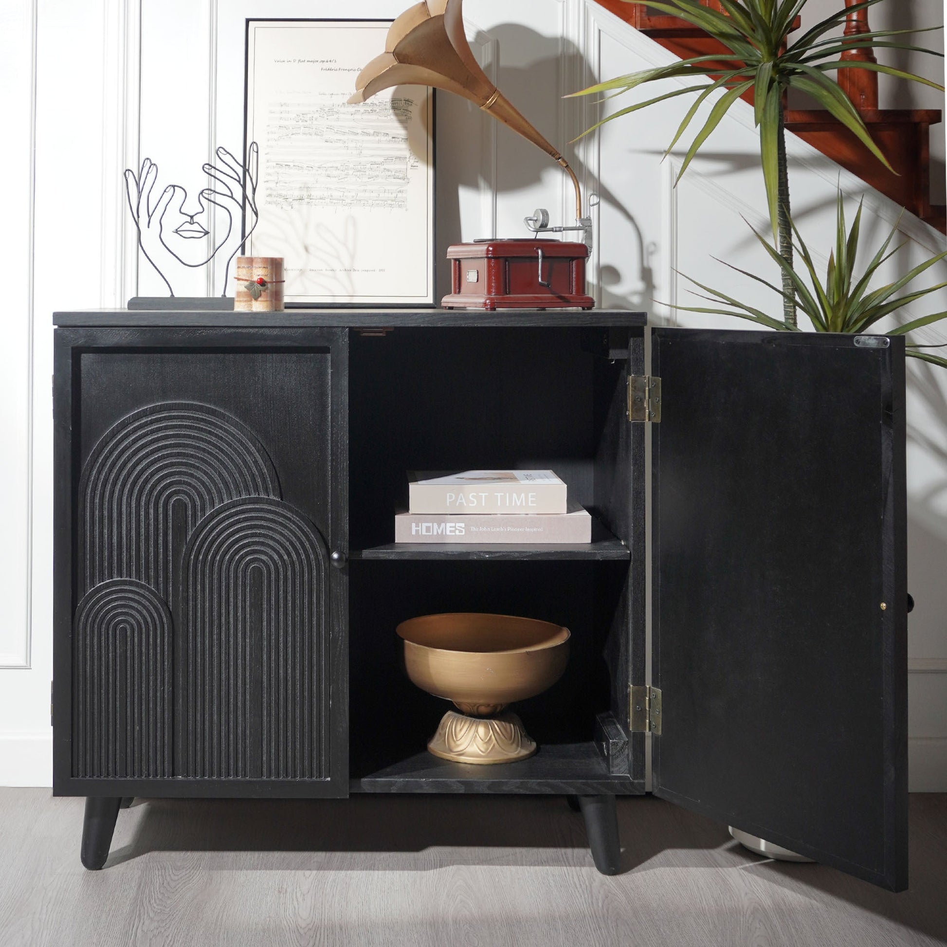 Modern black wood storage cabinet with embossed circular doors, red gramophone atop on Tampa Home & Garden Store