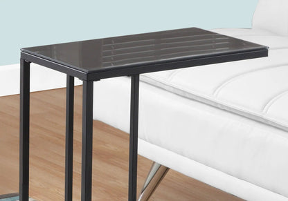 C-shaped accent table with black metal frame and glossy glass top beside a white sofa on Tampa Home & Garden Store