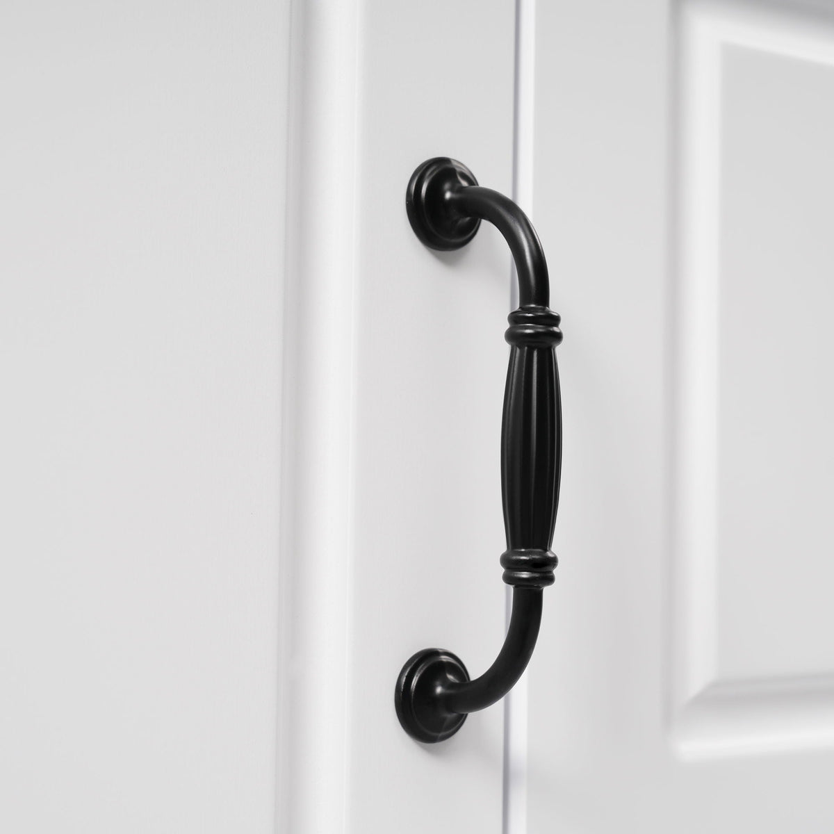 Bathroom vanity door handle black curved metal on white cabinet on Tampa Home & Garden Store