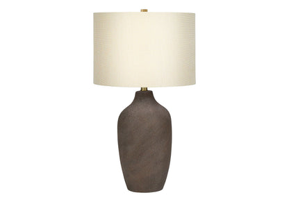 Table lamp with textured brown ceramic base, beige fabric shade, brass finial on Tampa Home & Garden Store