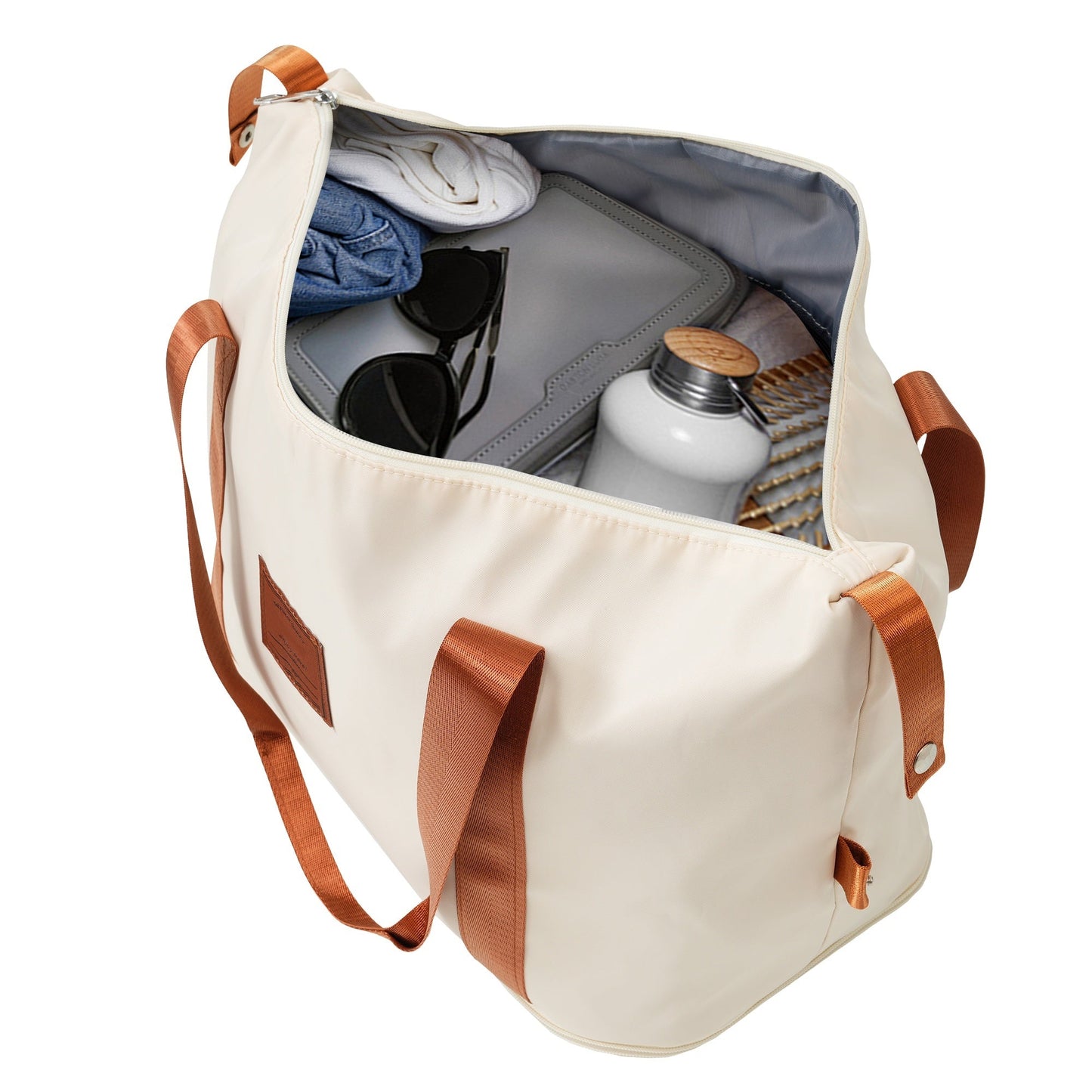 Luggage tote HouseOfZazla in cream with copper straps, interior shows clothes and accessories on Tampa Home & Garden Store