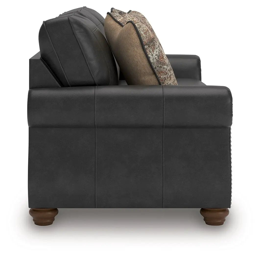 Chasemore Sofa black leather stationary sofa with brown wooden feet and cushions on Tampa Home & Garden Store
