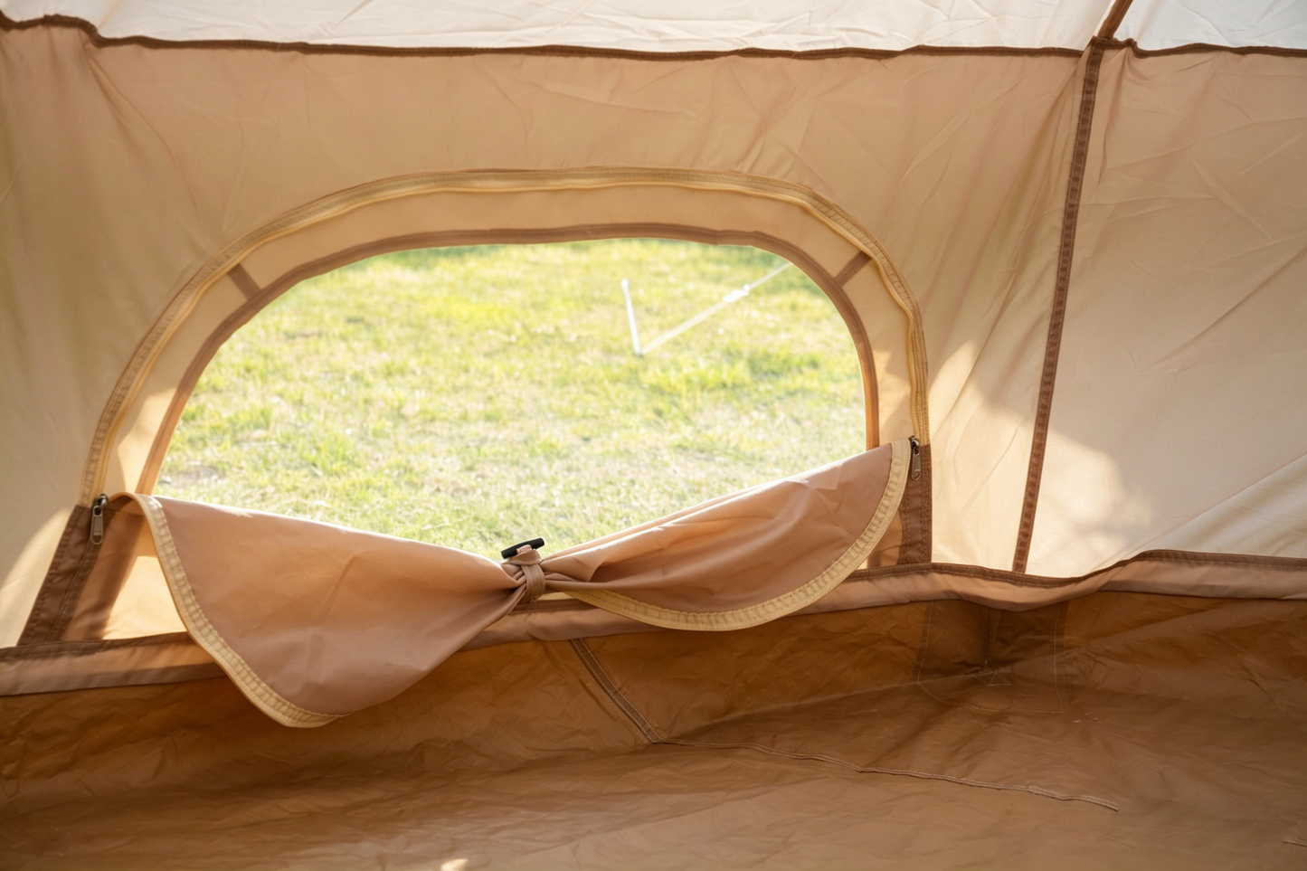 Beige Oxford Bell Tent interior with circular zippered doorway for family camping on Tampa Home & Garden Store