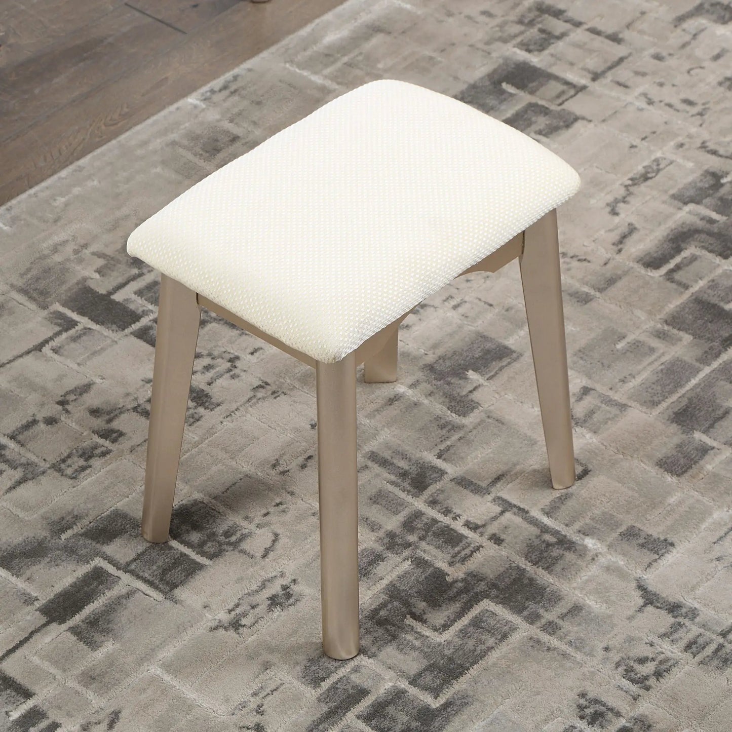 Maly contemporary wood vanity stool with cream dotted upholstery and gold legs on Tampa Home & Garden Store
