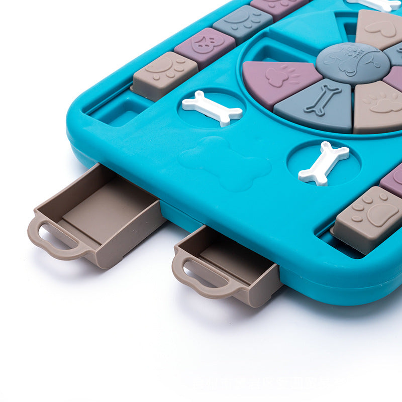 Interactive dog toy with teal base, pastel puzzle, slow-feeding feature and two pull-out drawers on Tampa Home & Garden Store