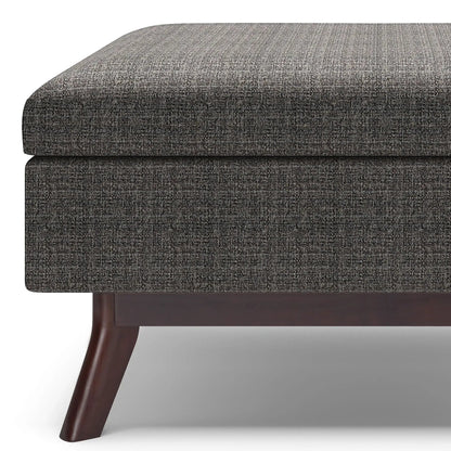 Owen Upholstered Rectangular Storage Ottoman in dark gray fabric with wood legs on Tampa Home & Garden Store