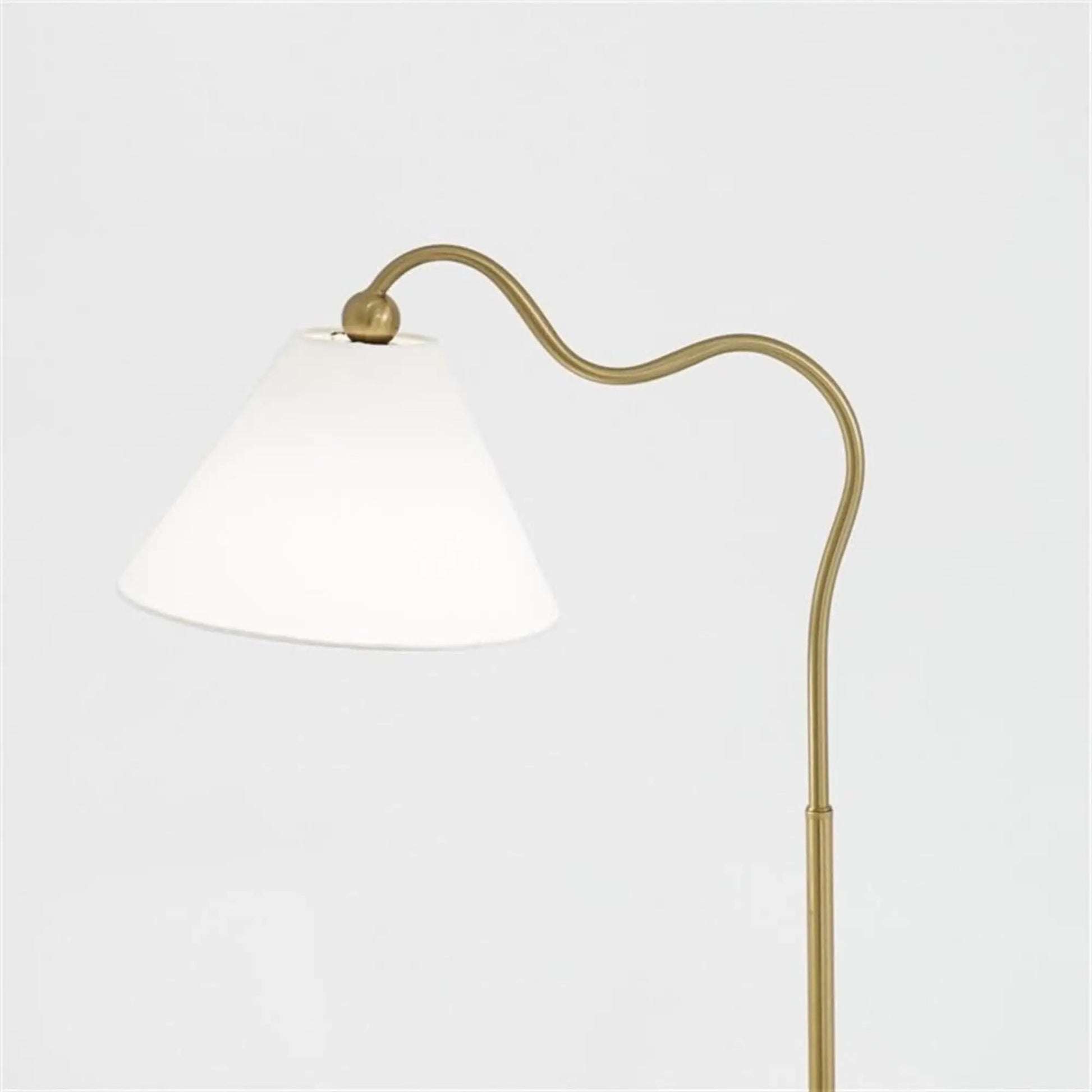 Ornate ring-base curved table lamp with gold finish and white triangle drum shade on Tampa Home & Garden Store