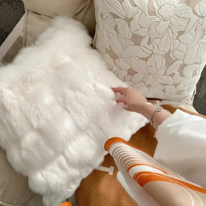 French Magnolia sofa pillow case in white faux fur on beige couch with leaf-pattern cushions on Tampa Home & Garden Store