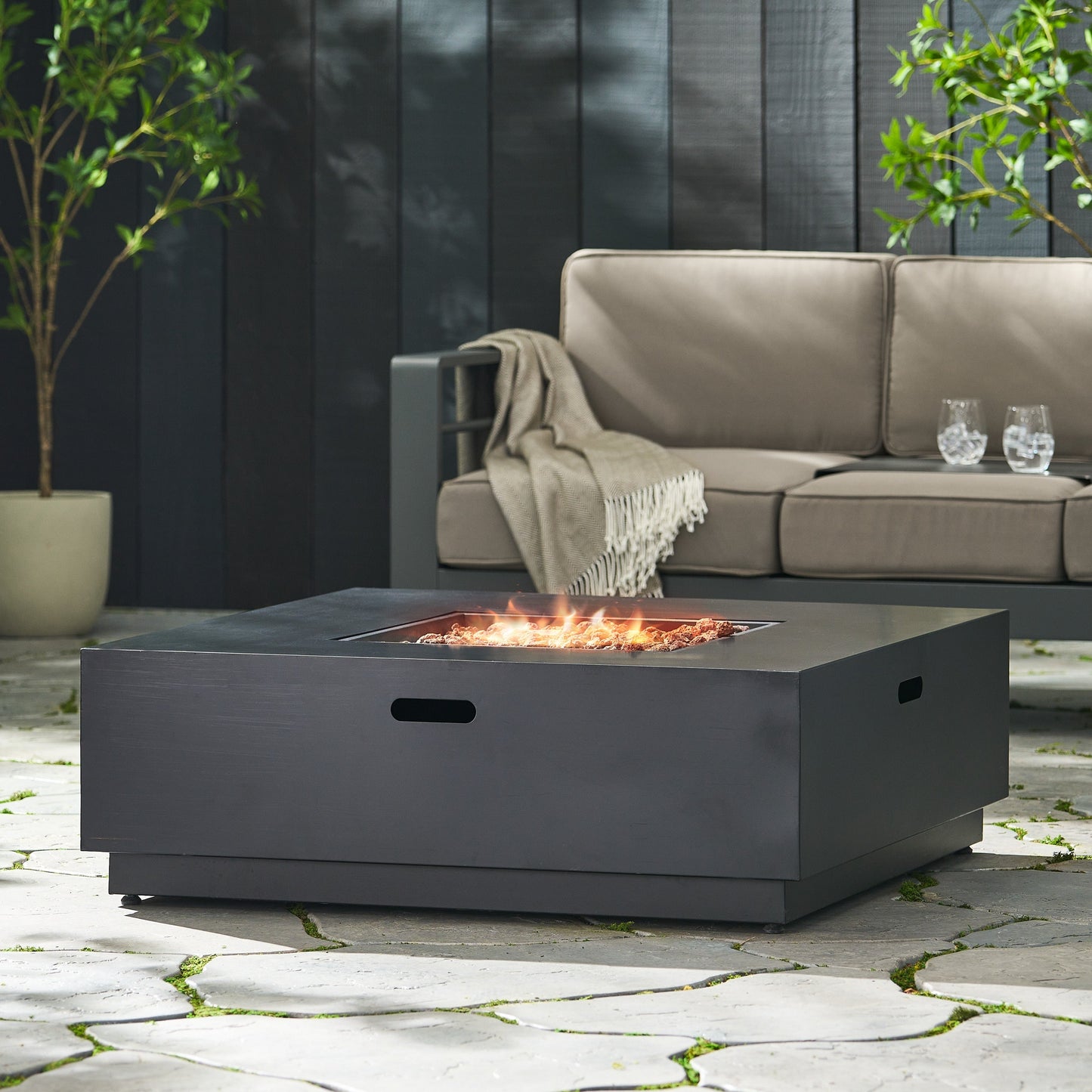 39in square iron fire pit table with 50,000 BTU flame display in an outdoor lounge on Tampa Home & Garden Store
