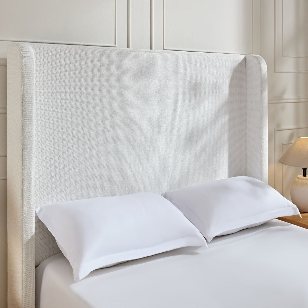 Harper tall headboard upholstered bed in cream fabric with white bedding on Tampa Home & Garden Store