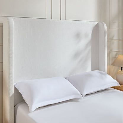 Harper tall headboard upholstered bed in cream fabric with white bedding on Tampa Home & Garden Store