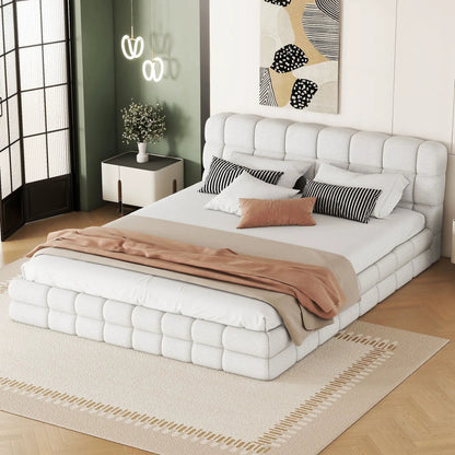 Upholstered platform bed with light gray tufted headboard and white bedding with pillows on Tampa Home & Garden Store