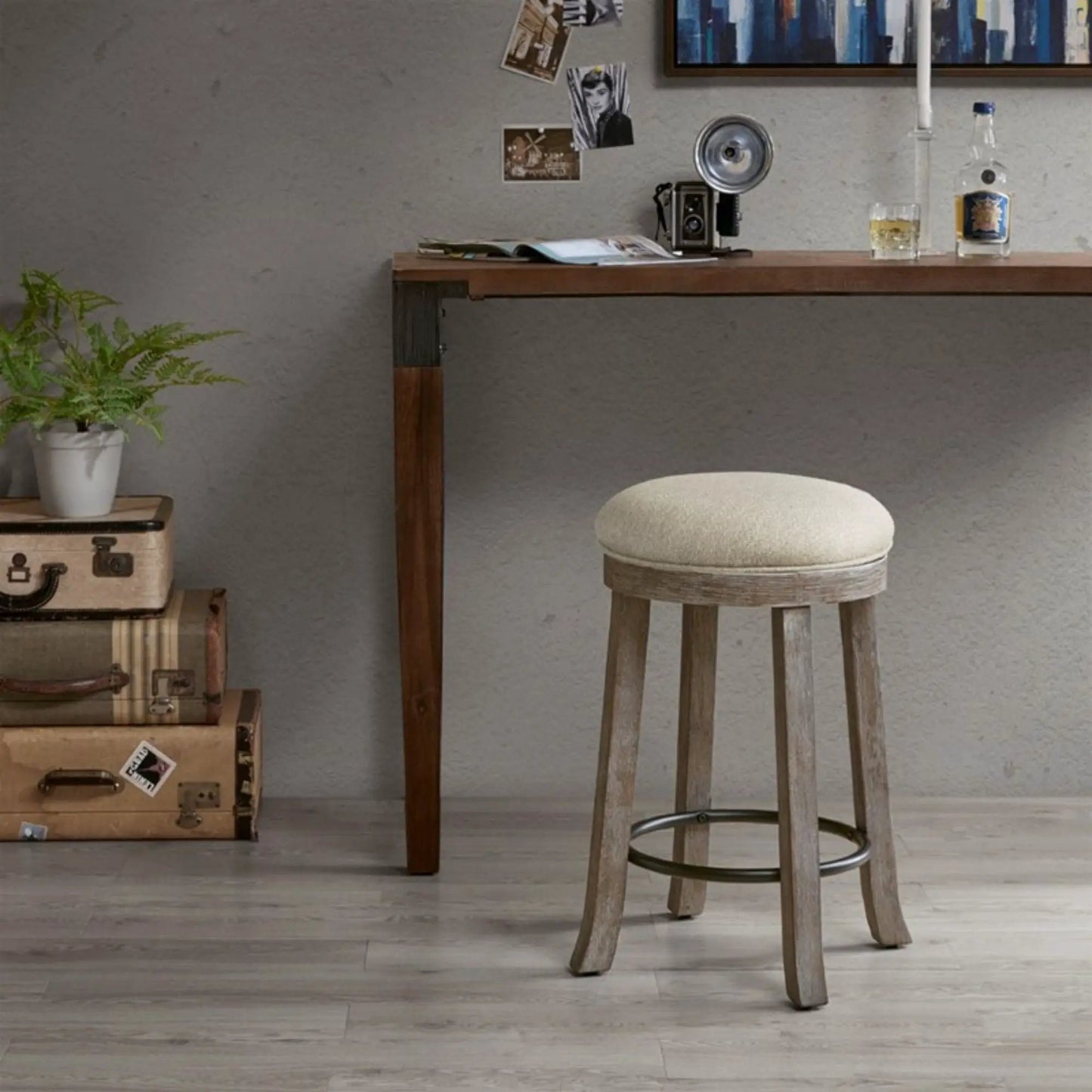Swivel counter stool with cream upholstered seat and reclaimed gray wood legs, metal footring on Tampa Home & Garden Store